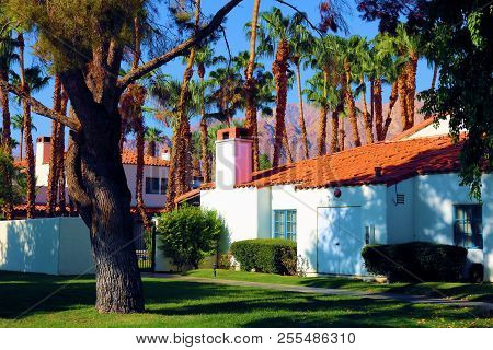 August 26, 2018 In La Quinta, Ca:  Palm Trees And A Green Lawn Surrounding Spanish Style Casitas Tak