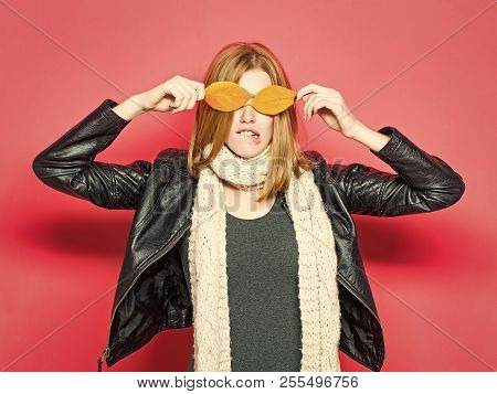 Beauty And Fashion. Woman With Autumn Leaves As Glasses In Leather Jacket. Girl With Orange Leaves O