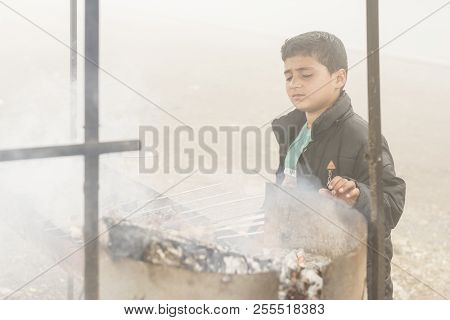 Gilan Province- Iran-july 23, 2018 Portrait Of A Teenage Boy Making Kebab In Fogy Day Beside Travel 