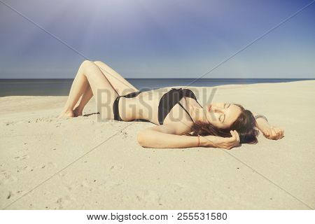 Beautiful Young Woman In Swimsuit At Sand Sea Beach, Toned Image