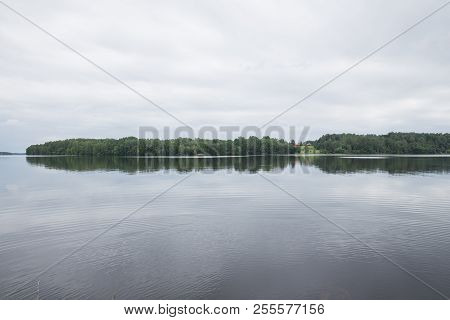 Latvia. Old River And Green Trees. Ruins And Reflection.