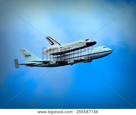The Us Shuttle, The Enterprise On Top Of A Boeing 747 Jet Flying Over Nyc, On Its Way To The Intrepi