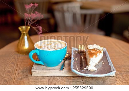 Blue Coffee Cup Baked Fruit Pie On Wooden Tray Over Modern Cafe Iterior