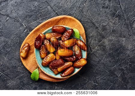 Dried Dates Fruits On Plate With Copy Space. Top View Of Pitted Dates.