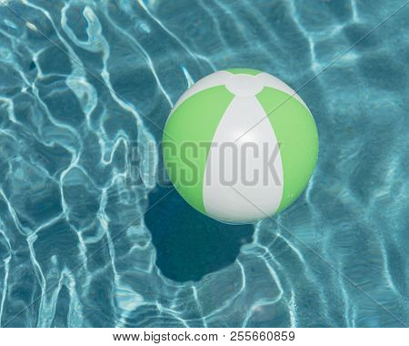 Close-up One Bright Green Beach Ball In Swimming Pool Sunny Day