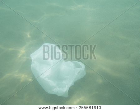 Plastic Bag Floating Into The Sea. Polluted Enviromental. Recycle Garbage