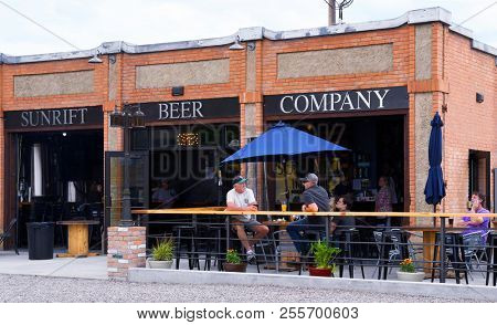 KALISPELL, MONTANA, USA - June 17, 2018: Patrons drink beer outside Sunrift Beer Company microbrewery