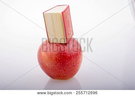 Red Apple And  Islamic Holy Book Quran In Mini Size