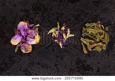 Nymphaea Caerulea - Blue Lily, Calea Zacatechichi And Clitoria Ternatea On Black Table, From Above. 