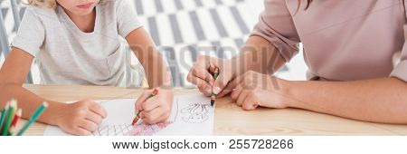 Close-up Of Kids Drawing Pictures During Art Classes At School