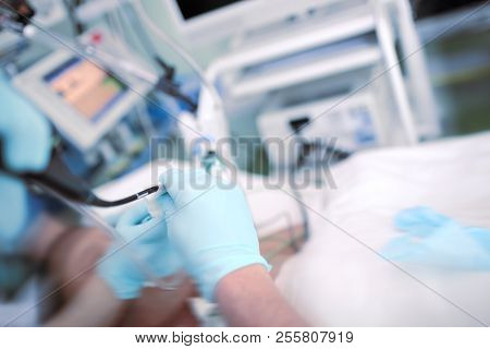 Doctor Performing Endoscopic Procedure To The Patient In The Icu.