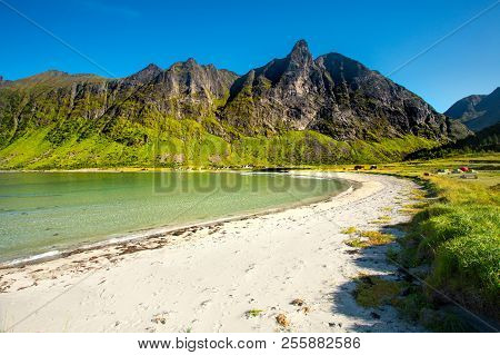 Norway. Senja Island. Northern Beach With White Sand By The Rocks. Summer Norway Landscape. Clear Su