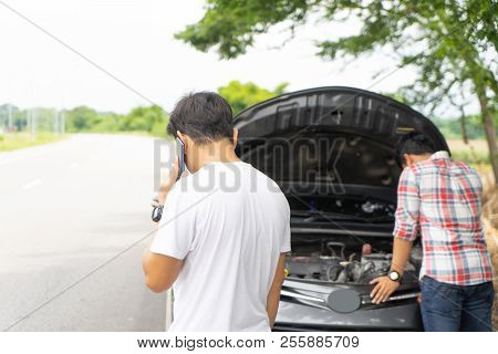 Friends Call And Fixing Car Broken Down By The Roadside.
Couple Young Man Calling For Assistance Bre