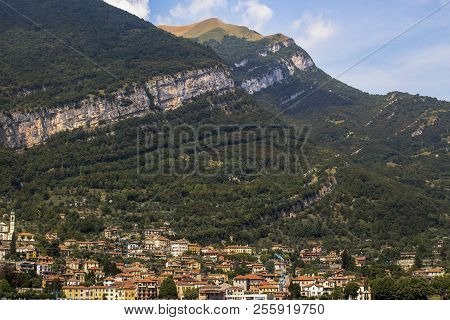 Look At The Village Of Torno At The Foot Of The Magnificent Alpine Hills, Northern Italy.