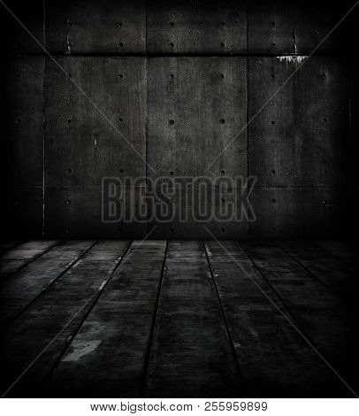 Very dark concrete wall and floor. Dim and cold space.