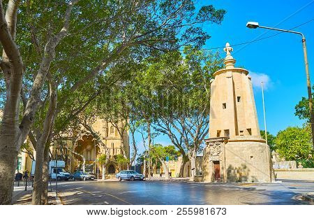The Shady Sarria Street With A View On Wignacourt Water Tower And Former Methodist Church, Known As 