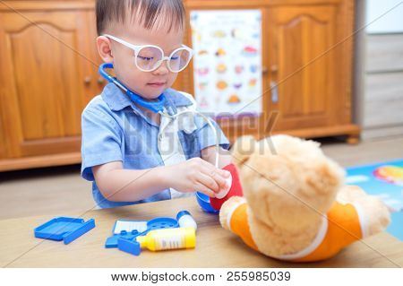 Cute Little Asian 2 Years Old Toddler Baby Boy Child Playing Doctor With Plush Toy At Home, Kid Hold