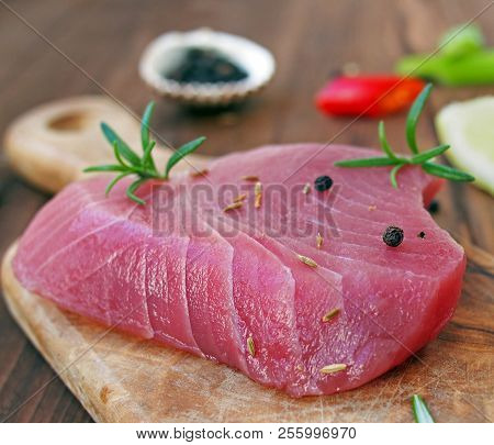 Fresh And Raw Tuna Steak With Chili Peppers And Olive Oil