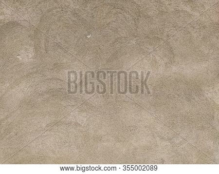 Concrete Surface With Multi-colored Blotches Of Small Stones. Light Beige Tone. Wall Of A Building O