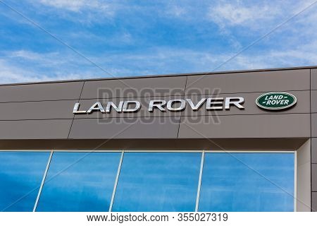 Land Rover Brand Logo On Bright Blue Sky Background Located On Its Dealer Office Building In Lyon, F