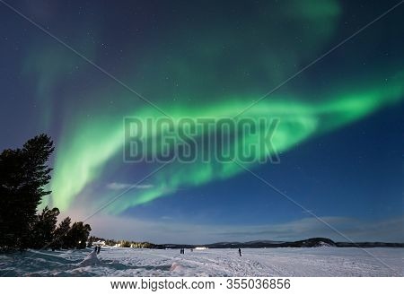 Aurora Borealis Over Lake Inari Near Inari Town In Lapland In Northern Finland.