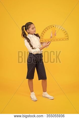 Setting Square With Protractor. Little Girl Using Triangle To Measure Angles In Degrees On Yellow Ba