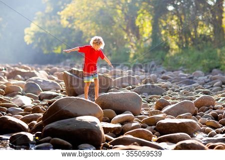 Child Hiking In Mountains. Kids At River Shore.