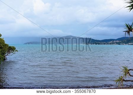 A Rainstorm Coming Across The Sea In A Shower Of Wet Weather In A Coastal Bay