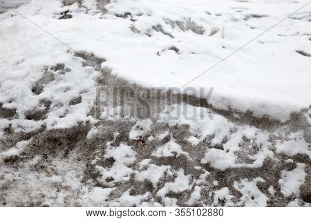 Dirty Snow Spring Background. Old And Dirty Snow Texture. Natural Background. Snow Mixed With Coal S
