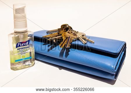 St Elizabeth, Jamaica - March 06 2020: Purell Advanced Hand Sanitizer Gel With Keys And Purse On Whi