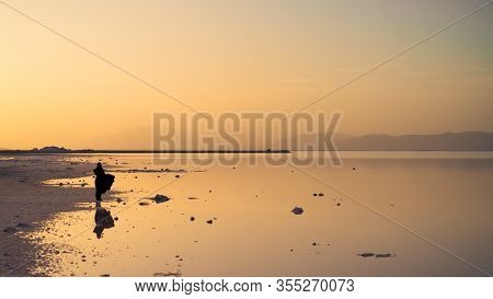 Mahorloo, Shiraz, Iran - May 2019: Unidentified Iranian Woman By Maharloo Pink Lake With Her Reflect