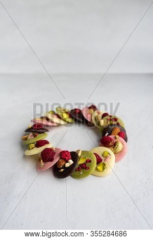 Belgian Mediants Of Different Chocolate On A Gray Background