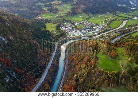 Aerial View Of Green Meadows With Villages And Forest In Austrian Alps Mountains.