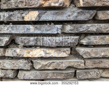 The Surface Of A Stone Wall. Masonry Walls Of Old Stone Blocks.