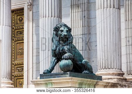Madrid, Spain - May, 2018:  Lion Statue At The Palacio De Las Cortes Building In Madrid House Of  Th