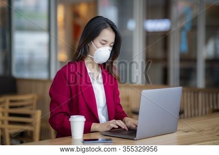 Asian Girl Use A Protection Mask For Prevent Pm 2.5 And Corona Viruus Or Covic 19 In Office In Bangk