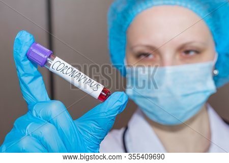 Nurse Wearing Face Mask Holding A Positive Blood Test Result For The New Rapidly Spreading Coronavir