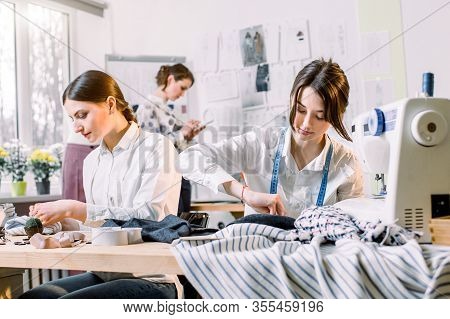 Portrait Of Young Fashion Dressmakers Women At Work. Dressmaker, Tailor, Fashion And Showroom Concep