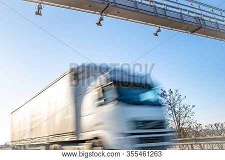 Truck Drive Through The Highway Through The Toll Gate, Toll Charges, Blurred Motion In The Image