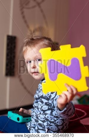 Little Boy Collects The Puzzle Sitting On Floor. Big Abc Squishy Foam Puzzle. Learning Alphabet With