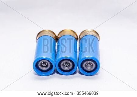 Three Blue 12 Gauge Rifled Shot Gun Slugs On A White Background