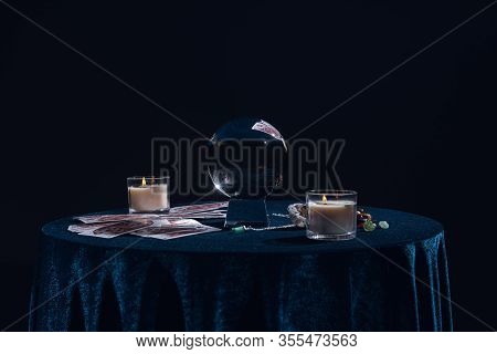 Kyiv, Ukraine - January 9, 2020: Crystal Ball With Candles, Tarot Cards, Stones And Chain On Round T