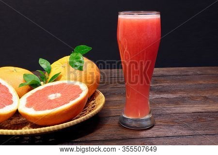 A Glass Of Fresh Grapefruit Juice And Grapefruit Fruits On A Wooden Table. Healthy Food.