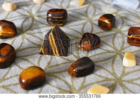 A Close Up Image Of A Prosperity Grid Using Tiger Eye And Citrine Crystals.