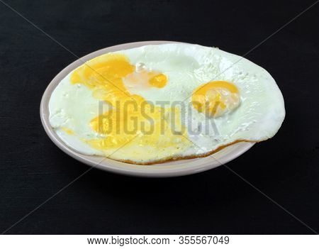 Three Fried Eggs Lie On A Plate