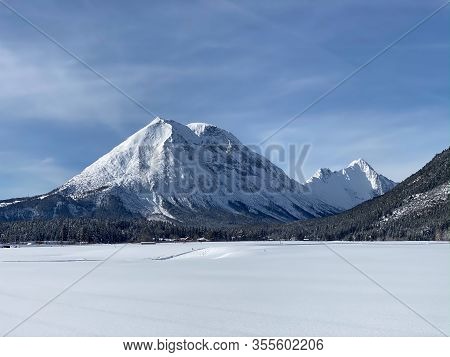 Winter Mountains Landscape With Groomed Ski Track And Dramatic Sky, Leutasch, Austria. The Village O
