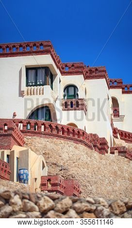 Middle Eastern Style Residential Building With Brick-built Fence On A Cliff.