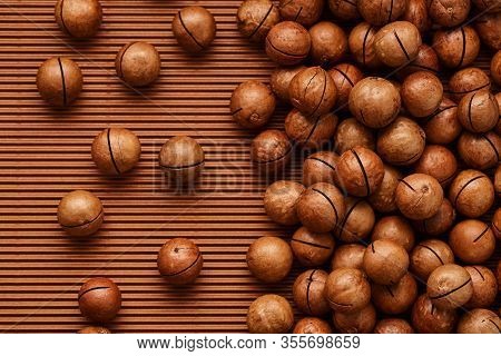 Fresh Macadam Nut Close-up On A Brown Background
