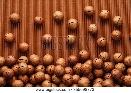 Fresh Macadam Nut Close-up On A Brown Background