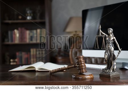 Lawyers Office Concept. Law Symbols Composition - Gavel And Themis Statue On  Wooden Shining Desk.